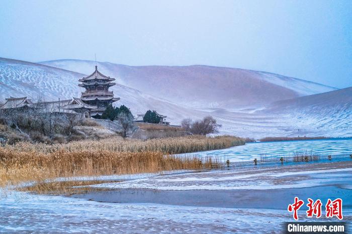 2021年11月28日，雪落鳴沙山月牙泉景區(qū)?！⊥醣筱y 攝