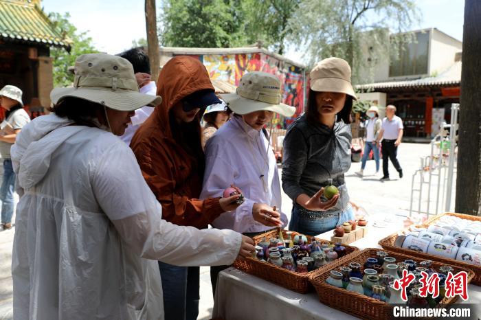 圖為民眾挑選手工藝產(chǎn)品?！⊙Φ?攝