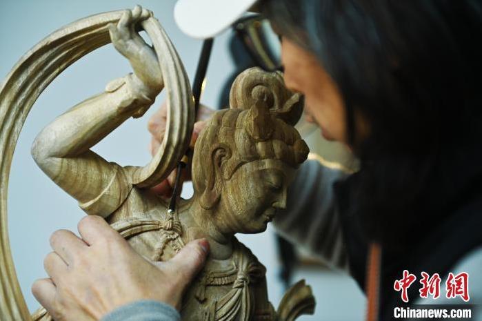 圖為季茂杰進行敦煌元素的木雕創(chuàng)作。李亞龍 攝</p>
<p>